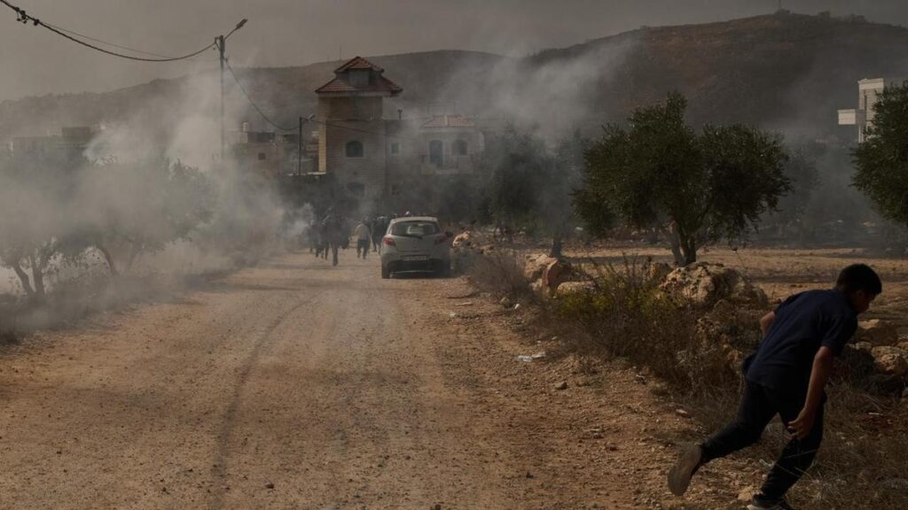 Israeli settlers burn trees, hurt reporter in West Bank
